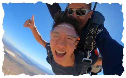 Tandem skydiver giving thumbs up