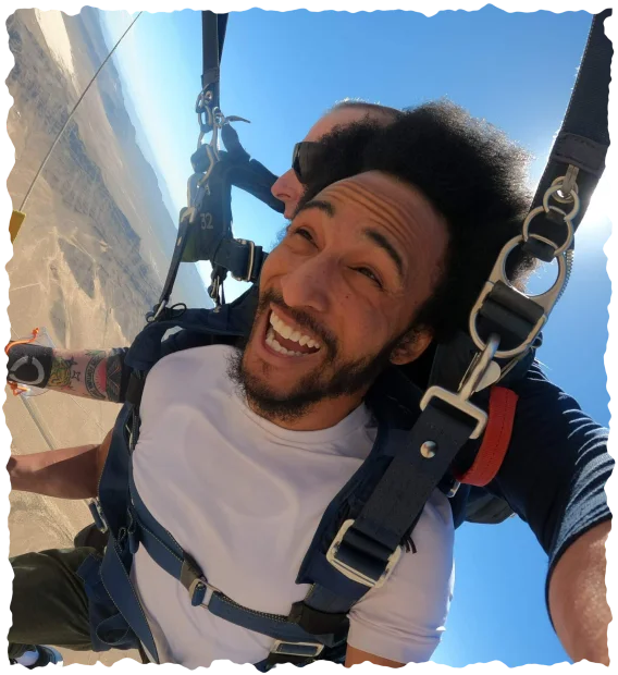 Smiling tandem skydiver over Las Vegas desert