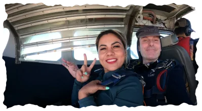 Skydivers giving peace signs inside airplane